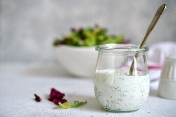 Fresh homemade salad dressing with garlic and dill.