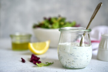 Fresh homemade salad dressing with garlic and dill.