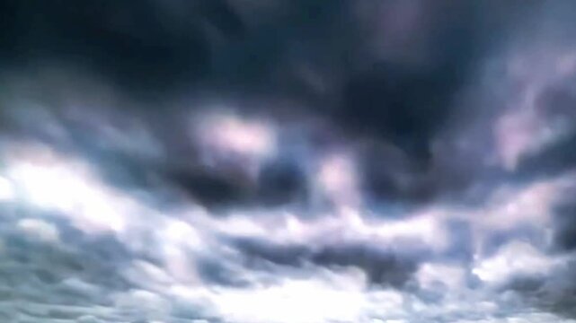 Dramatic storm clouds rolling over the sky in time-lapse. Dark, ominous weather with intense wind and movement. Thunderstorm atmosphere and cinematic sky animation.