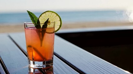 Refreshing tropical cocktail with lime and mint garnish, summer beach vacation, relaxation, seaside leisure, holiday escape beverage