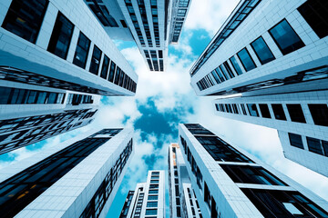 A group of tall buildings with a blue sky in the background