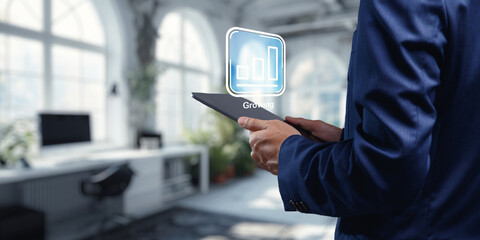 Businessman Holding Tablet with Growth Icon in Modern Office Space