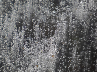 Close-up of ice with frozen bubbles in a ditch outdoors in winter