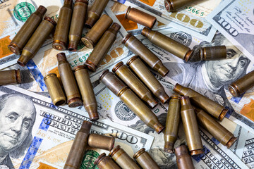 Background with American dollars and cartridges for a machine gun. World conflict in the world