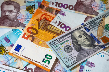 Background with Ukrainian money and American dollars and euros