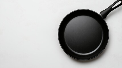 Empty Black Frying Pan on White Surface Ready for Cooking Delicious Meal