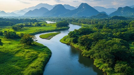 Serene River Flowing Through Lush Green Landscape Surrounded by Majestic Mountains Under a Blue Sky at Sunset