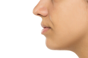 Obraz premium Profile view of female facial features showing nose, lips, and skin texture. Natural, no makeup look with soft lighting. Clean, minimal skincare concept