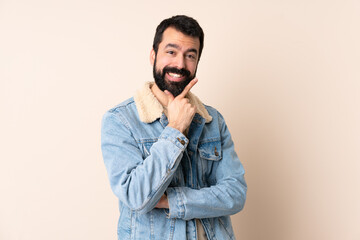 Fototapeta premium Caucasian man with beard over isolated background happy and smiling