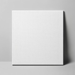 A minimalist white square box placed on a soft grey background creating a calm and elegant composition