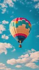 Fototapeta premium Colorful Hot Air Balloon Floating in a Clear Blue Sky