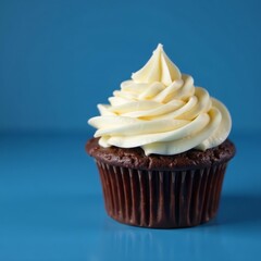 Close up of chocolate cupcake with vanilla frosting on blue table, dessert, icing, delicious