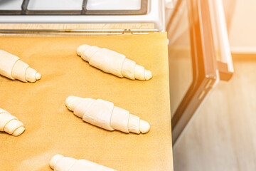 a tray of croissants in a home kitchen. making croissants at home. homemade baked goods. croissant...
