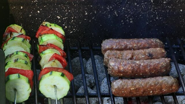 cevapcici and vegetable skewers on grill

