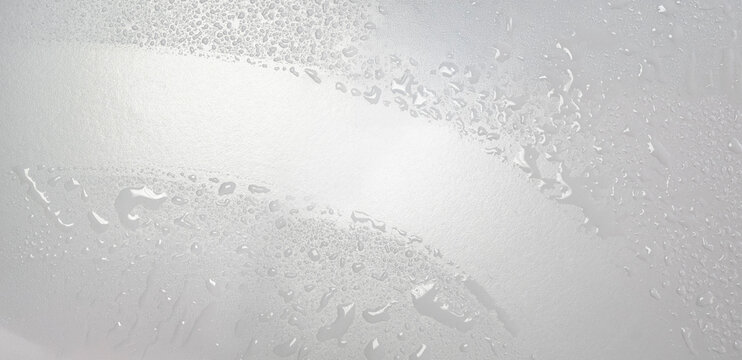 Wipe the glass pane with a glass cleaner and rubber puller. Hygiene, waterdrops or splashes, blotches desinfection on a clear surface.