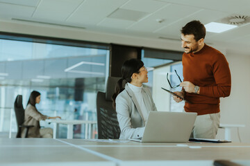 Office collaboration between colleagues during a vibrant workday in a modern workspace