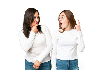 mother and daughter over isolated chroma key background standing and thinking an idea