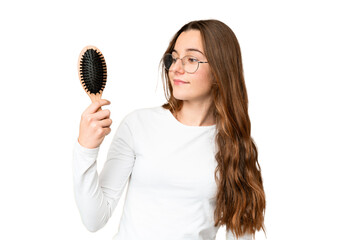 Teenager girl with hair comb over isolated chroma key background with happy expression