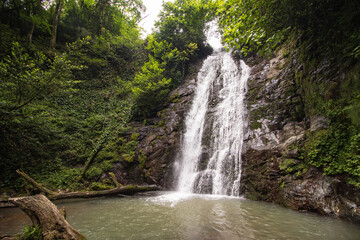 Fototapeta premium Beautiful Kapnistavi waterfall in the green forest. Adjara, Georgia