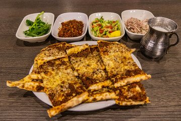 Meal in Turkey - dish of pide with side dishes and ayran drink