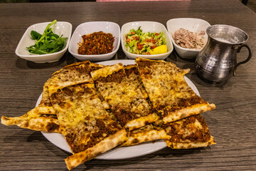 Meal in Turkey - dish of pide with side dishes and ayran drink