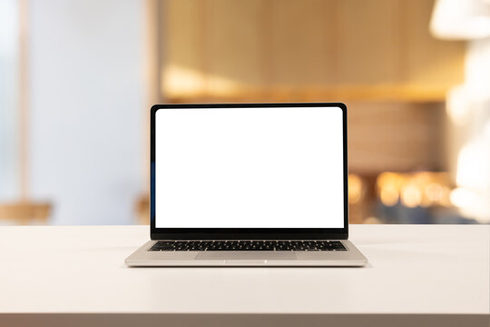 close up on laptop with white blank isolated screen display on table over the luxury private of CEO or manager office room for add content and design about creative or business task concept