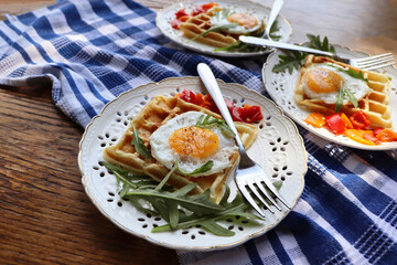 Healthy breakfast . Freshly made, delicious meal of eggs and vegetables. Gluten-free buckwheat waffles with fried eggs Top view