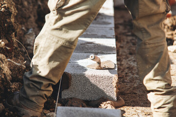 Bricklayer lay concrete blocks for foundation