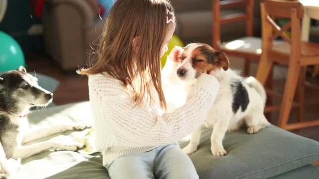 7 year old girl hugs cute little dog