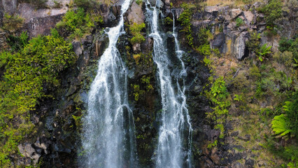 A waterfall and it´s nearby vegetation in Tasmania, seen from above