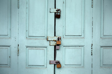 Vintage Mint Green Doors with Multiple Padlocks Closed Securely
