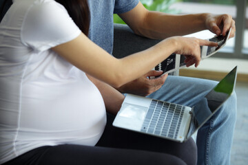 Expecting Parents Reviewing Ultrasound Images in Modern Setting