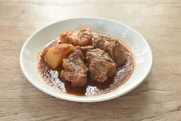 beef curry or Mussamun Indian food with slice potato on plate 