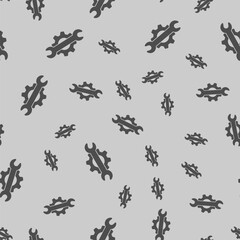 Wrench on cogwheel gear solid seamless pattern, repair service theme. Vector graphics. Repair tool sign background, filled with glyphs icon.