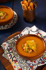 Wooden plate with Lentil Soup seasoned with green onions. Served with crispy breadsticks. Vegetarian concept. Side view