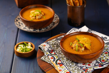 Red Lentil Soup with ingredients on wooden background, top view, copy space. Traditional turkish or arabic lentil and vegetable spicy soup, healthy vegan food.
