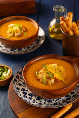 Red Lentil Soup with ingredients on wooden background, top view, copy space. Traditional turkish or arabic lentil and vegetable spicy soup, healthy vegan food.
