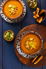 Red Lentil Soup with ingredients on wooden background, top view, copy space. Traditional turkish or arabic lentil and vegetable spicy soup, healthy vegan food.