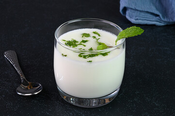 Serving Indian buttermilk in a glass cup.