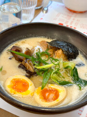 A bowl of ramen with noodles, meat and green onions. Japanese cuisine