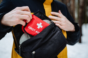 A person is currently holding a small first aid kit securely tucked away inside their pocket, ready...