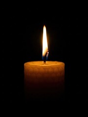 burning candle on black background
