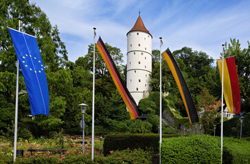 White tower with flags, park and parts of the city wall in Biberach an der Riss; taken from the...