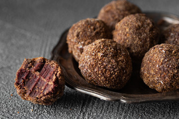 Artisan chocolate truffle candies with berry and fruit filling on dark background, handmade or handcrafted bonbons, chocolatier or confectionary concept. Horizontal banner, copy space