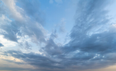 Cloudy sky with dynamic formations and varying shades of blue, creating a captivating atmosphere...