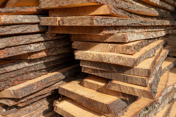 Wooden planks. Air-drying timber stack. Texture of folded wooden planks in a warehouse with a...