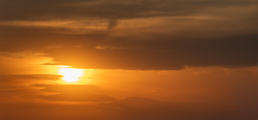 Beautiful bright evening sunset sky with dark  clouds. Sunset sky background.