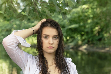Fototapeta premium Adorable cool brunette young woman is posing on camera outdoors Horizontally. 