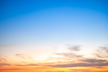Obraz premium Beautiful , luxury soft gradient orange gold clouds and sunlight on the blue sky perfect for the background, take in evening,Twilight, Large size, high definition landscape photo