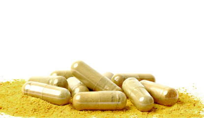 Ginger powder in capsules. isolated on white background.